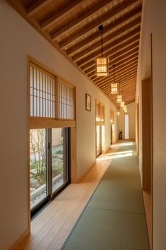 an empty hallway with sliding glass doors leading to another room