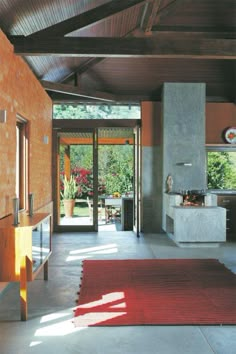 a living room filled with furniture and a red rug