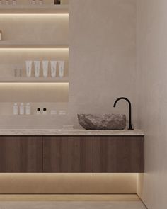 a bathroom with wooden cabinets and shelves filled with bottles