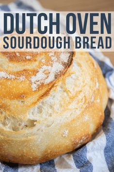 a loaf of sourdough bread sitting on top of a blue and white towel