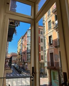 an open window looking out onto a city street