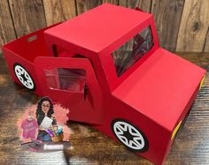 a paper model of a red truck with a woman's face on the side