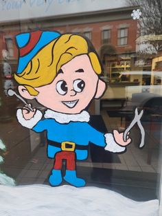 a glass window with a drawing of a boy holding a pair of scissors