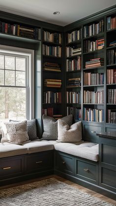 a living room filled with lots of books on top of a book shelf next to a window