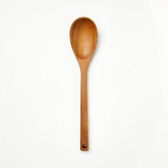 a wooden spoon sitting on top of a white table