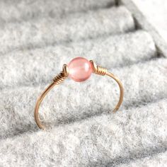 23.00 GBP This beautifully simple wire wrapped ring would make a perfect gift for someone you love, or a lovely treat for yourself! The ring is handmade using Sterling Silver, 14K Gold or 14K Rose Gold filled wire and a genuine Pink Tourmaline gemstone. The beautiful Watermelon Tourmaline stone is approximately 4mm. Tourmaline, the birthstone of October, aids in understanding oneself and others. It promotes self-confidence and diminishes fear. Tourmaline attracts inspiration, compassion,… Wire Ring Rose, Wire Jewelry Rings, Pink Watermelon, Wire Craft, Wire Jewelery, Pink Tourmaline Ring, Wire Wrapped Ring, Sterling Silver Wire Wrap, Diy Wire Jewelry