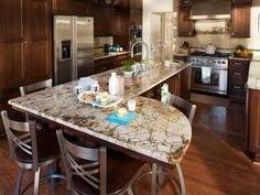 a large kitchen with an island and stainless steel appliances