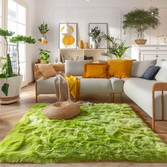 a living room filled with lots of furniture and plants on top of the rugs