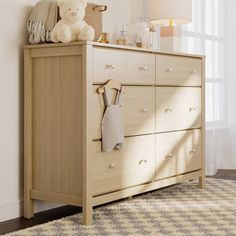 a teddy bear sitting on top of a dresser