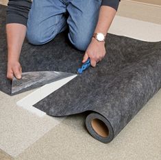 a person laying on the floor with a piece of felt