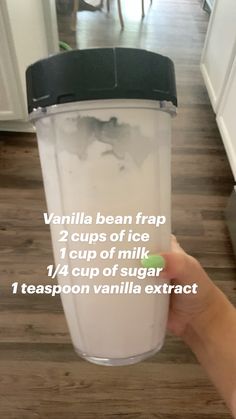 a person holding up a cup filled with vanilla bean frap 2 cups of ice 1 cup of sugar 1 teaspoon vanilla exact