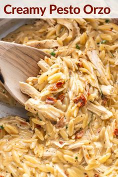 creamy pesto orzo pasta with chicken and parmesan cheese in a skillet