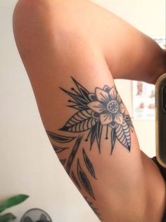 a woman's arm with a flower tattoo on it