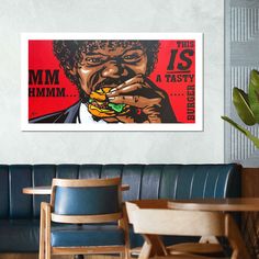 a painting of a man eating a burger in a restaurant with red and blue walls