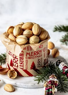 almonds in a paper bag with christmas decorations around it