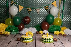 football themed birthday party with cake and decorations on wooden floored floor, balloons and streamers