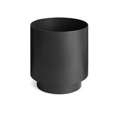 a black cup sitting on top of a white surface