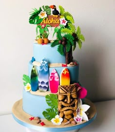 there is a blue cake with tropical decorations on it