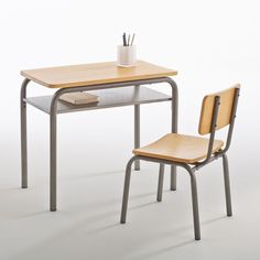 a desk with a chair next to it and a cup on top of the table