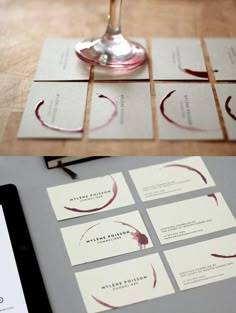 some wine glasses and business cards on a table