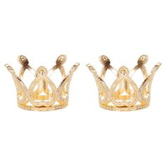 two gold crowns sitting side by side on top of each other in front of a white background