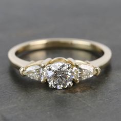 three stone engagement ring with diamond accents