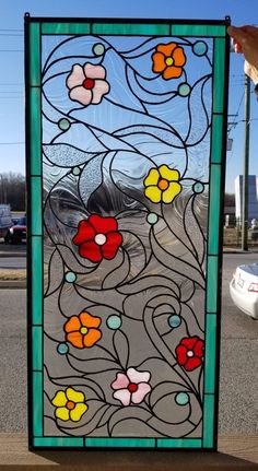 a large stained glass window sitting on the side of a road