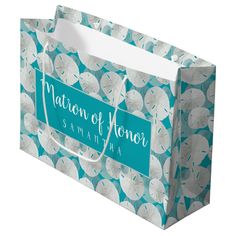 a blue and white paper bag with flowers on it