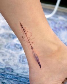 a small feather tattoo on the ankle