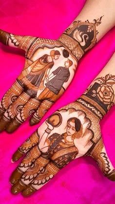 two hands with henna designs on them