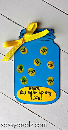 a blue mason jar with yellow ribbon hanging from it