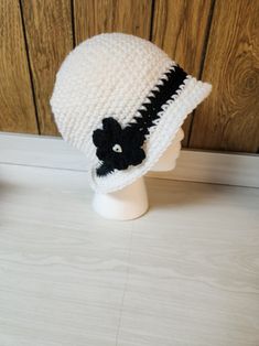 Add a unique and stylish touch to your winter or fall wardrobe with this handmade crochet bucket hat. The hat features a white and black color combination, making it a perfect match for your casual outfits. It is made from high-quality acrylic material and crochet fabric type with beautiful accents that add to its overall charm. This bucket hat is suitable for adults and is perfect for women who love the boho theme. The hat is carefully crafted in the United States, and it is ready to be shipped Handmade White Crochet Beanie Hat, Handmade White Crochet Bucket Hat, Handmade White Crochet Hat With Curved Brim, White Brimmed Bucket Hat Made Of Yarn, Casual White Brimmed Crochet Hat, White Brimmed Yarn Bucket Hat, Adjustable White Crochet Bucket Hat, White Adjustable Crochet Bucket Hat, White Adjustable Brimmed Crochet Hat