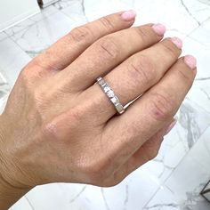 a person's hand with a ring on it