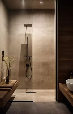 a bathroom with a sink, shower and large glass door in it's center