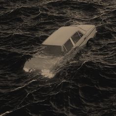 an old car is submerged in the ocean