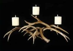 the antler candle holder has four candles in it