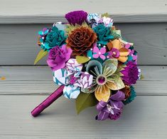 a bridal bouquet with paper flowers and leaves