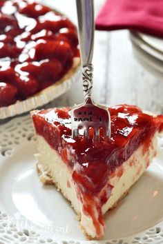 a slice of strawberry cheesecake on a plate with a fork