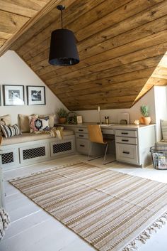 an attic bedroom with wood paneling and white walls