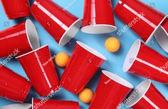 red plastic cups and orange balls on blue background