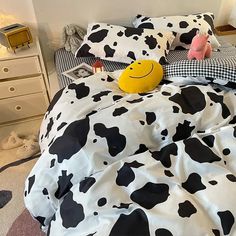 a black and white cow print comforter on a bed