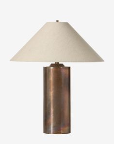 a table lamp with a white shade on it's base and a brown metal cylinder