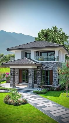 a modern house is shown with landscaping and mountains in the background