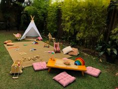 a child's play area in the backyard with toys and games on the grass