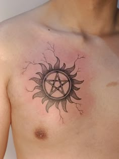 a man's chest with a pentagramil tattoo on it