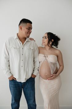 a pregnant couple standing next to each other