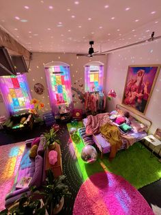 a living room filled with lots of furniture and colorful lights on the ceiling above it