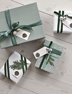 three presents wrapped in green and white paper