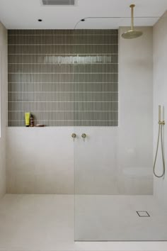 a bathroom with a walk in shower next to a window