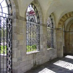 arched windows in an old building with stone walls